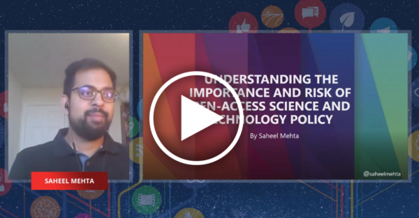 an indian man next to a presentation with a rainbow background, bearing the title of his talk