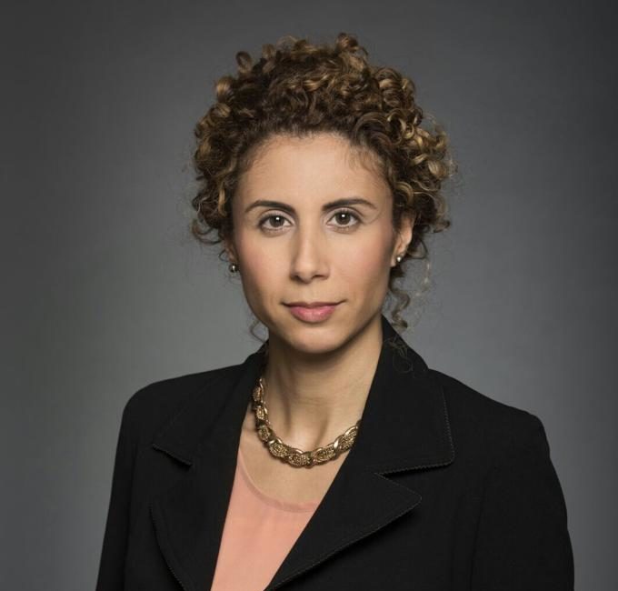 headshot of a white woman with curly hair