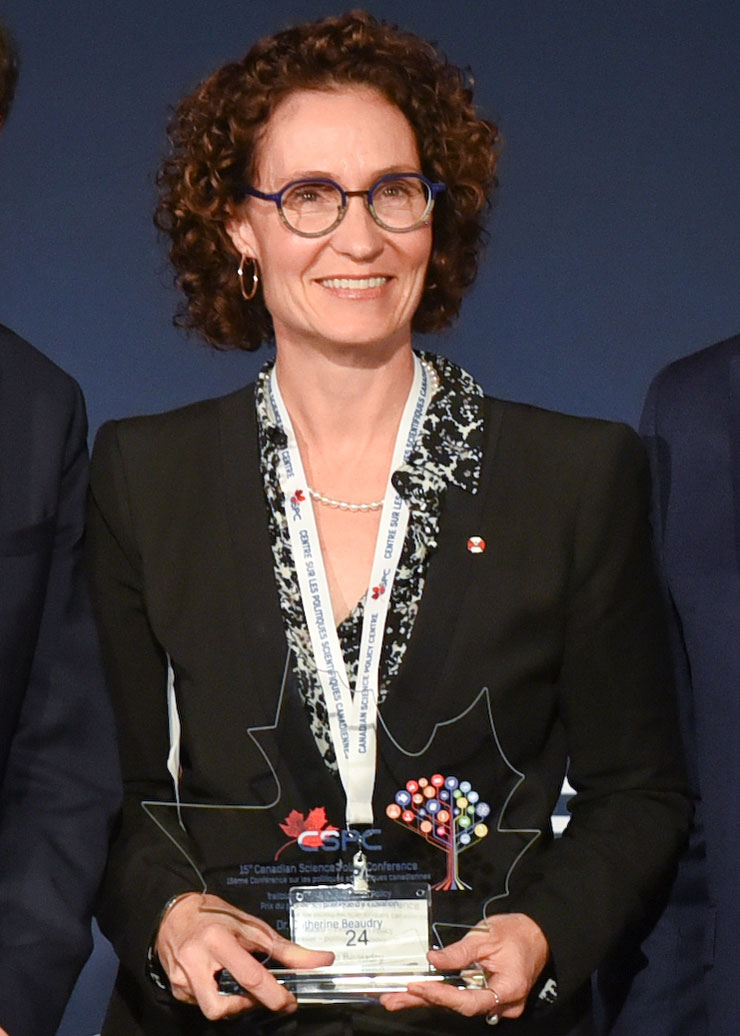 Dr. Catherine Beaudry holding award